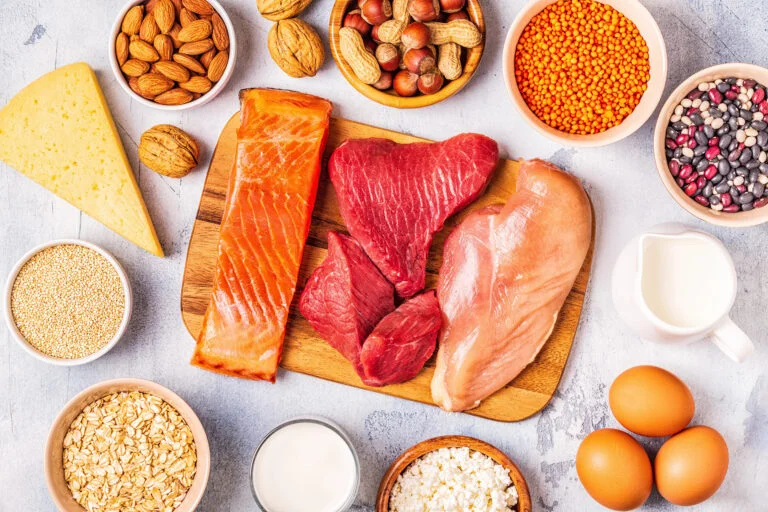 High-protein foods like salmon, chicken, and nuts for a muscle gain meal plan.