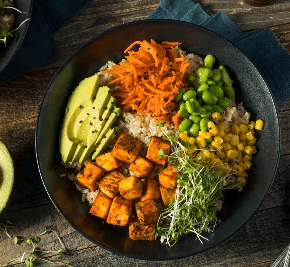 A balanced vegan bowl with tofu, avocado, and edamame for a 7-day meal plan for muscle gain